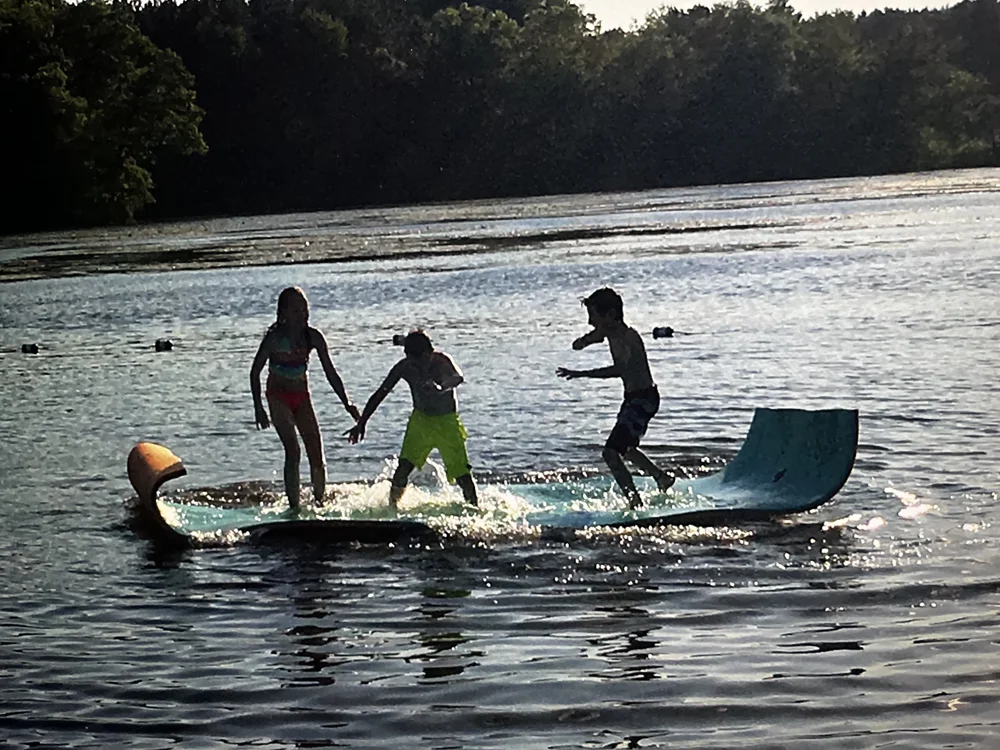 Children playing on a floating Maui Mat on the lake